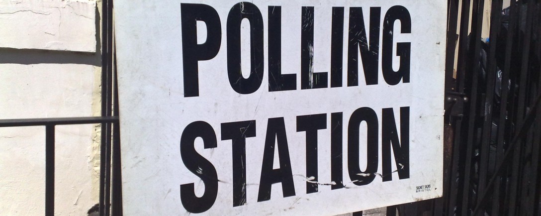 "Polling Station" sign attached to black metal railings